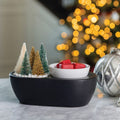 Lifestyle image: Bottle Brush Tree Wax Warmer styled in a holiday living room scene