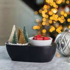 Lifestyle image: Bottle Brush Tree Wax Warmer styled in a holiday living room scene