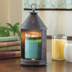 Primitive Tin Sunshine Lantern glowing over a jar candle on a living room shelf